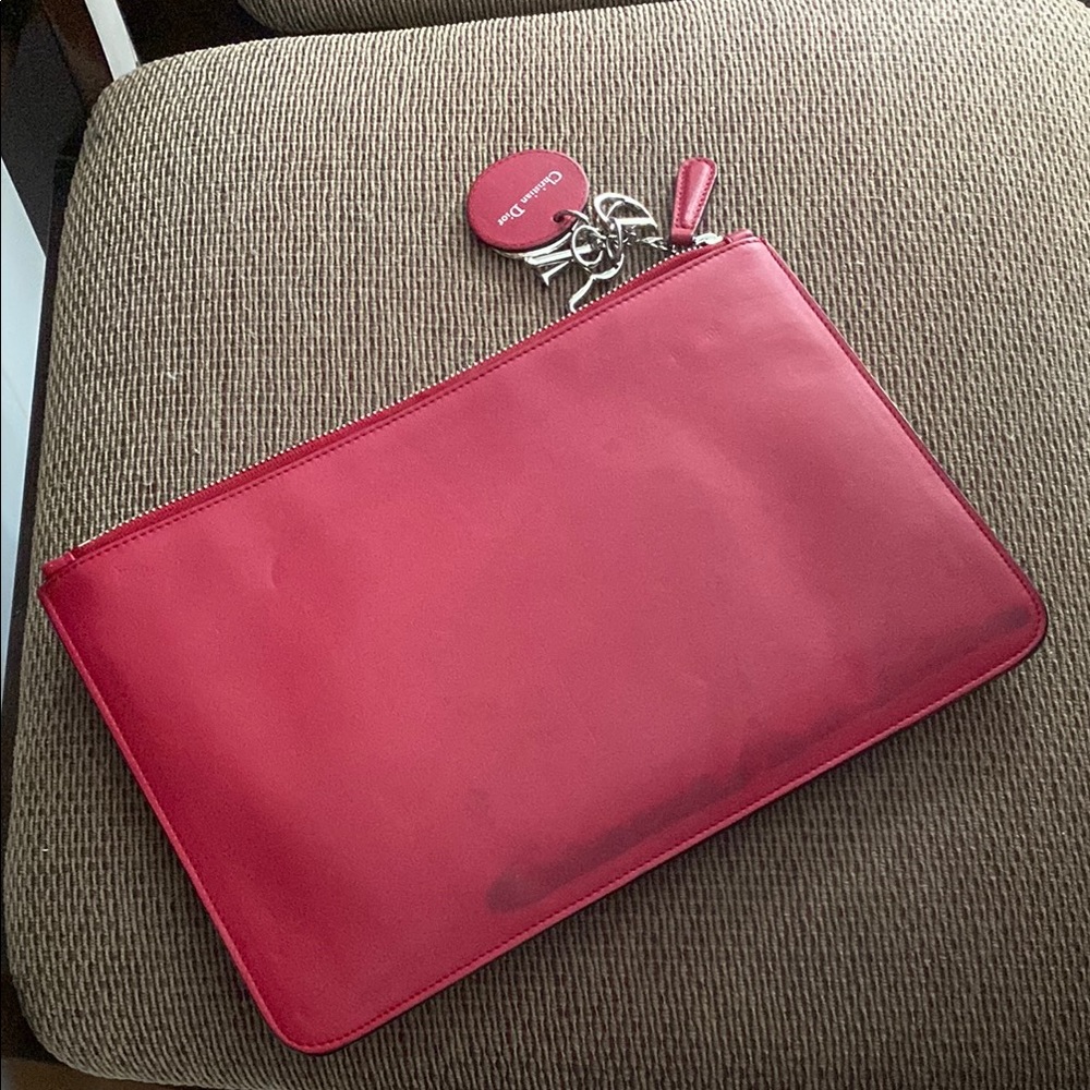 Christian Dior with stain at one side , color shade of red but not exactly red